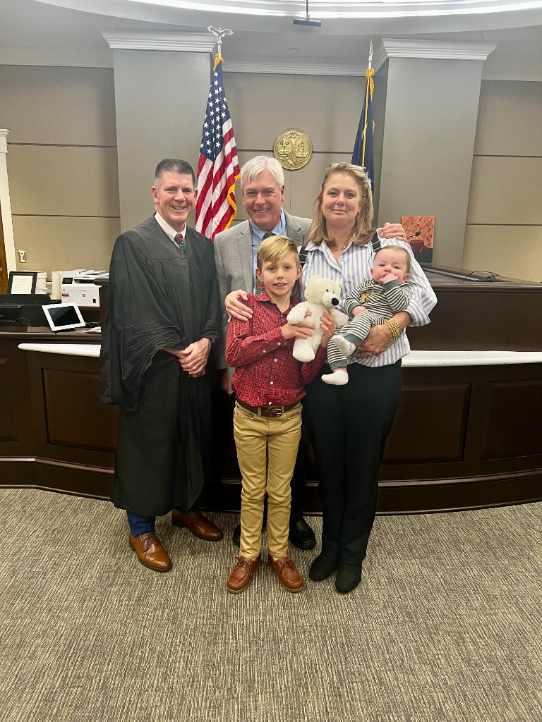 Family posing with the judge